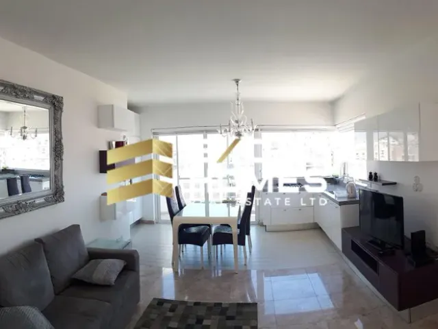 a living room with a couch, chairs, and a table