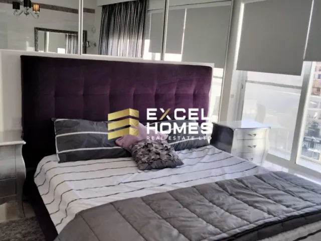a bed with a blanket and pillows on it