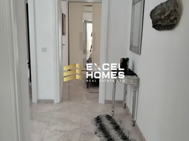 a room with a white wall and a black and white floor