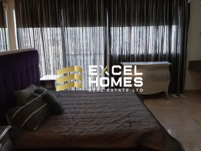 a bed with a white bedspread and a window