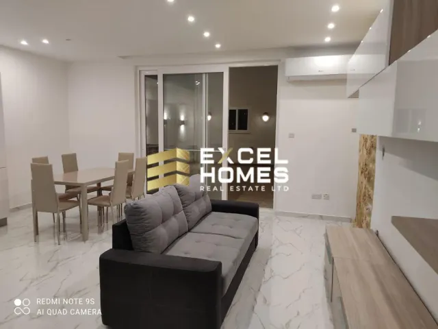 a living room with a couch, table and chairs
