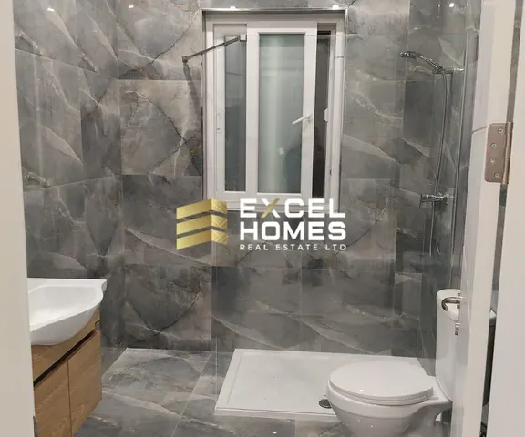 a bathroom with a shower, toilet and a sink