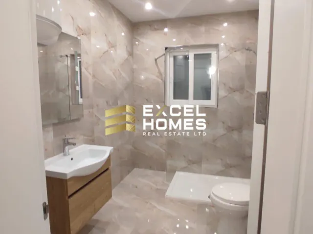a bathroom with a toilet, sink, and mirror