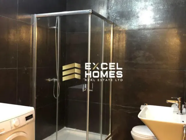 a bathroom with a shower stall and a toilet