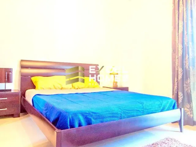 a bed with a blue and white bedspread and a blue and white bedspread 