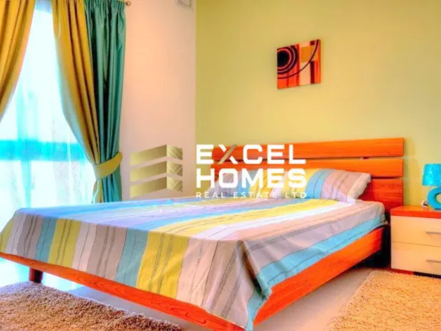 a bedroom with a bed, a desk and a lamp 