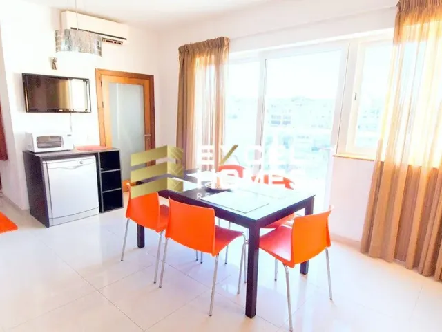 a kitchen with a table and chairs and a refrigerator 