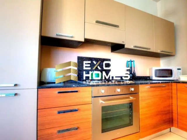 a kitchen with a stove, microwave, and refrigerator 