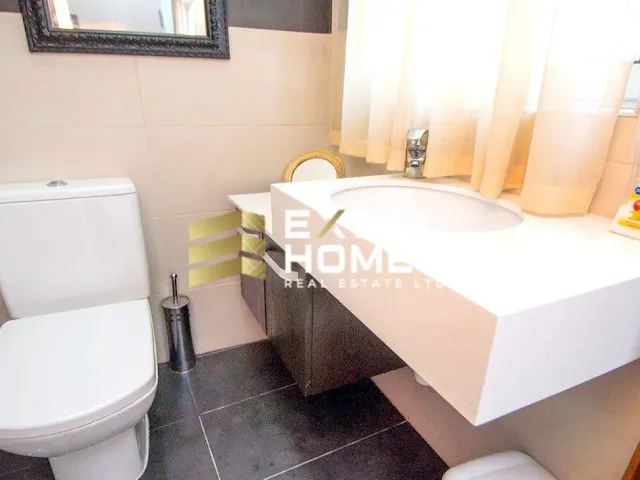 a white toilet sitting next to a white sink 