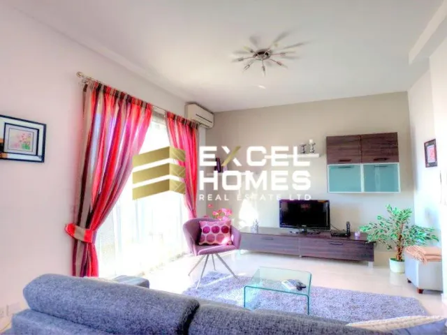 a living room with a couch, coffee table and a television 