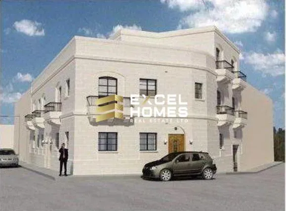 a car parked in front of a building with a sign