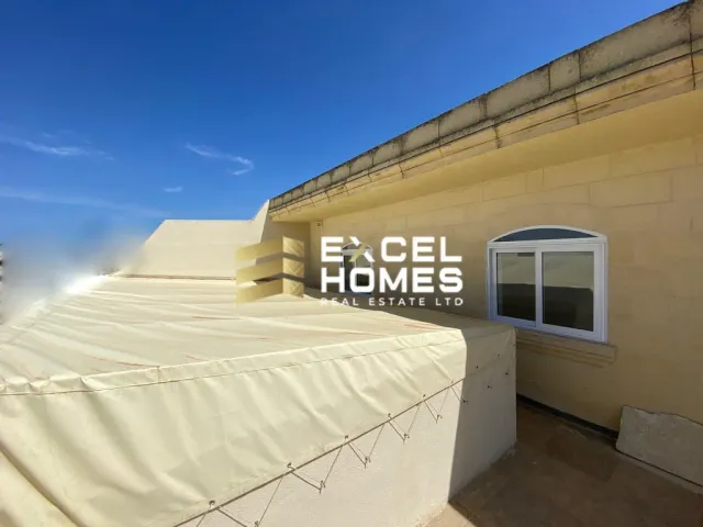 a white building with a white wall and a blue sky