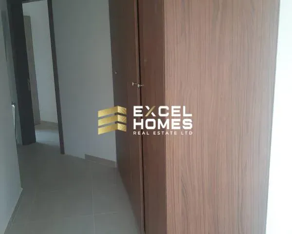 a door is open to a room with a wooden floor