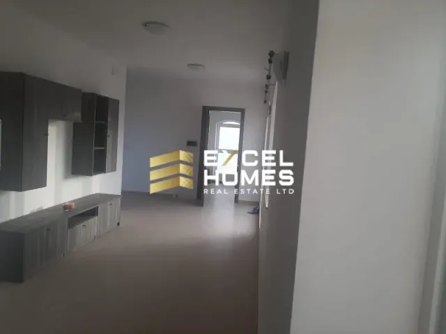 a room with a white wall and a black and white floor