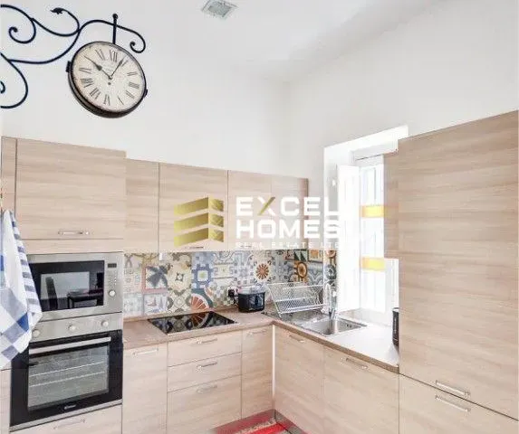 a kitchen with a stove, microwave, sink and refrigerator 