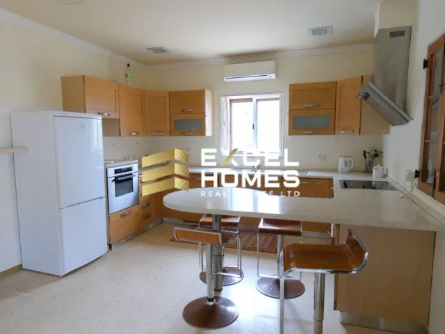 a kitchen with a stove, sink, and refrigerator