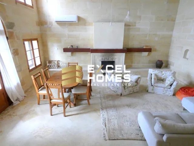 a living room with a fireplace and a table