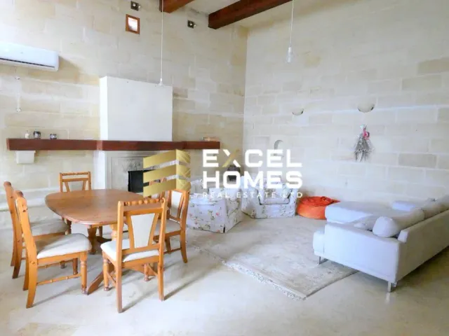 a living room with a couch, table, chairs and a table