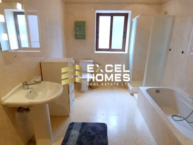a bathroom with a tub, sink, and toilet