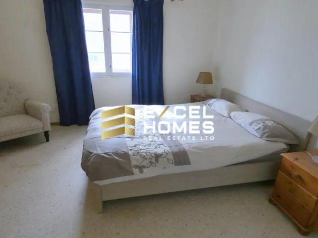 a bed with a white blanket and pillows