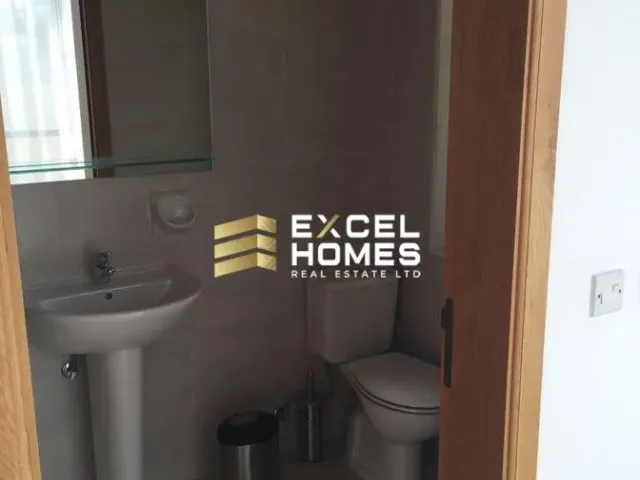 a bathroom with a toilet and a mirror