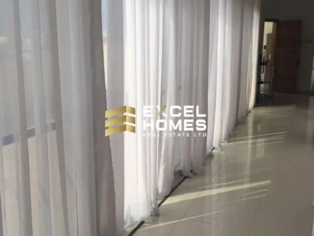 a room with a curtain and a window