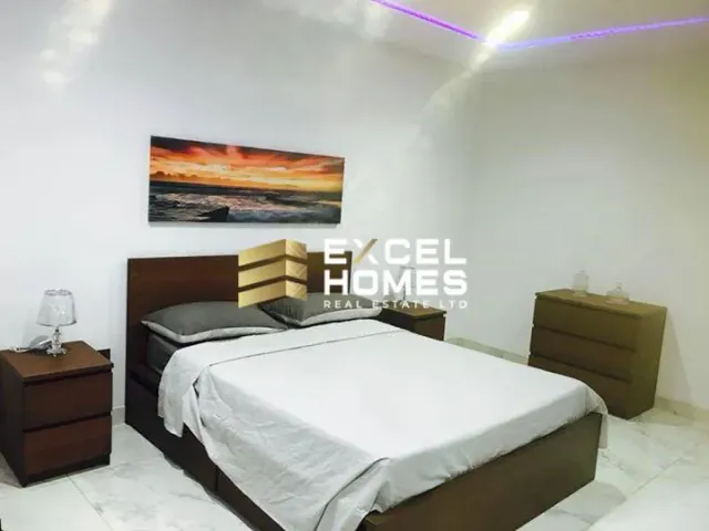 a bed with a white bedspread and a black and white bedspread 