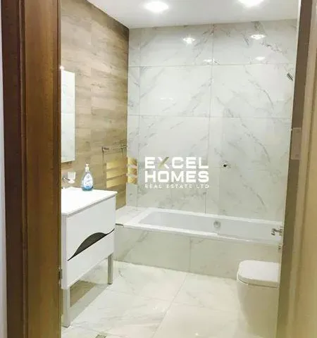 a bathroom with a tub, sink, and toilet 