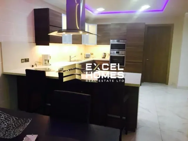 a kitchen with a sink, stove, and a counter 