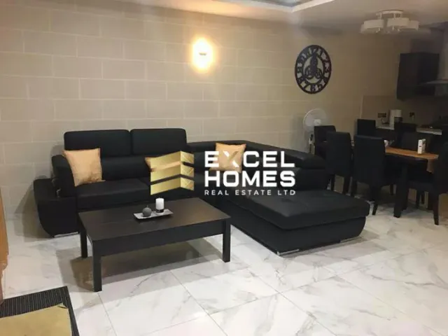 a living room with a couch, coffee table and a television 