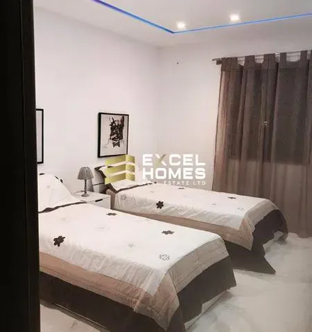 a hotel room with two beds and a television 