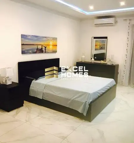 a bed room with a bed, chair, and table 