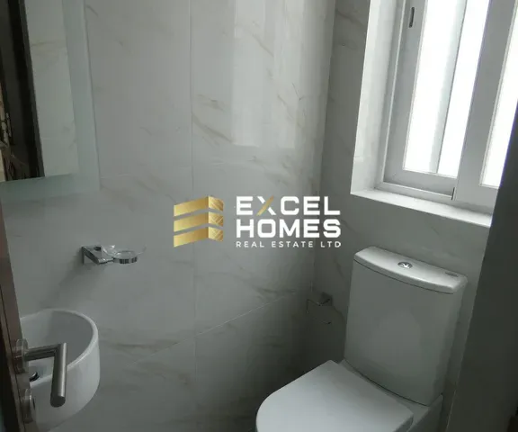 a bathroom with a toilet and a window 