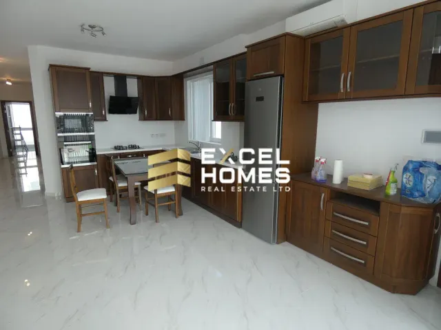 a kitchen with a stove, refrigerator, and a table 