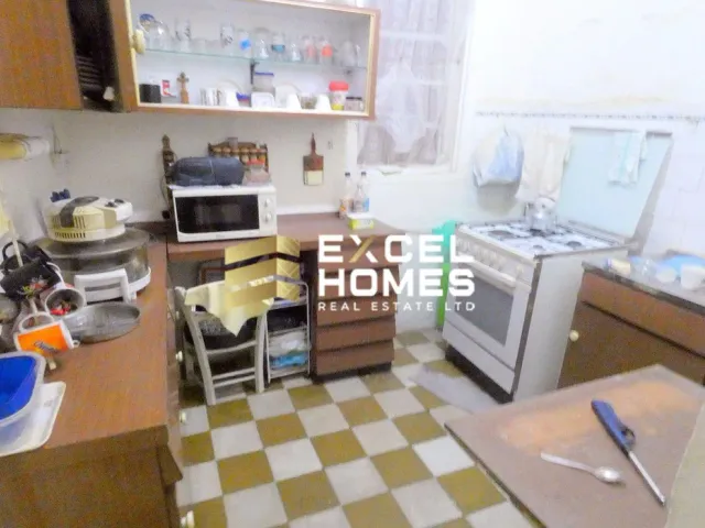 a kitchen with a stove, microwave, and a sink 