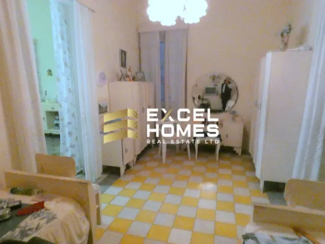 a bedroom with a bed, chair, and a table 