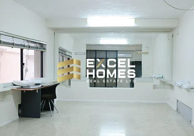 a room with a large window and a large desk