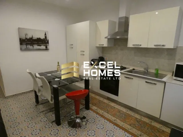 a kitchen with a table and chairs and a refrigerator