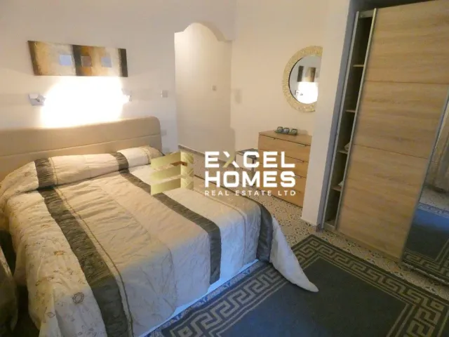 a bed with a pillow and a bedspread