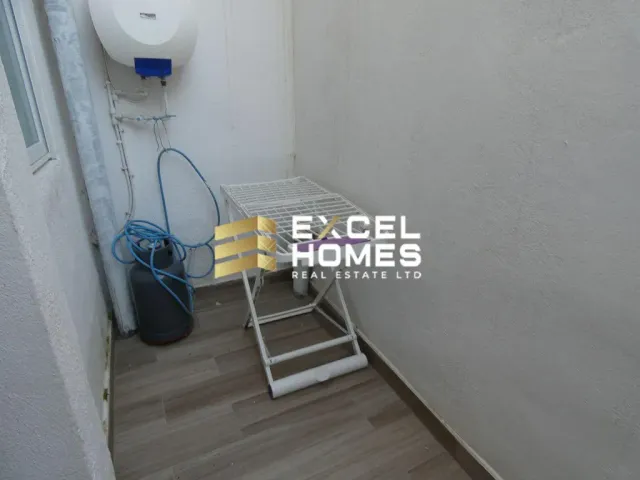 a small room with a toilet and a shelf