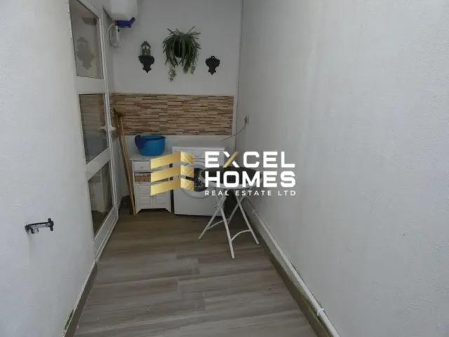 a room with a white wall and a black and white floor