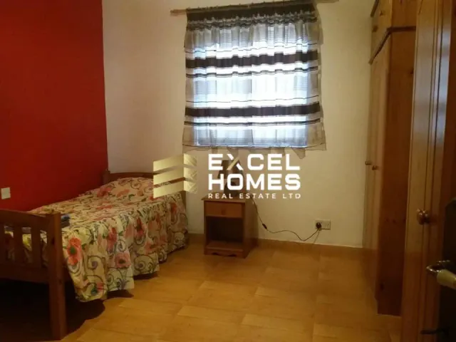 a bedroom with a bed, a dresser and a window