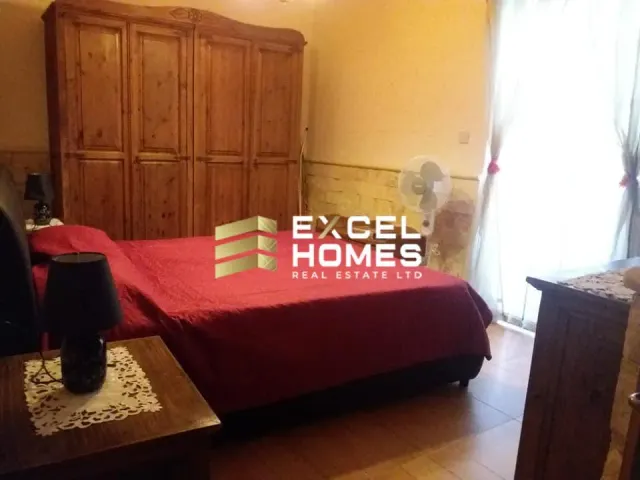 a bed with a red blanket and a red pillow on it