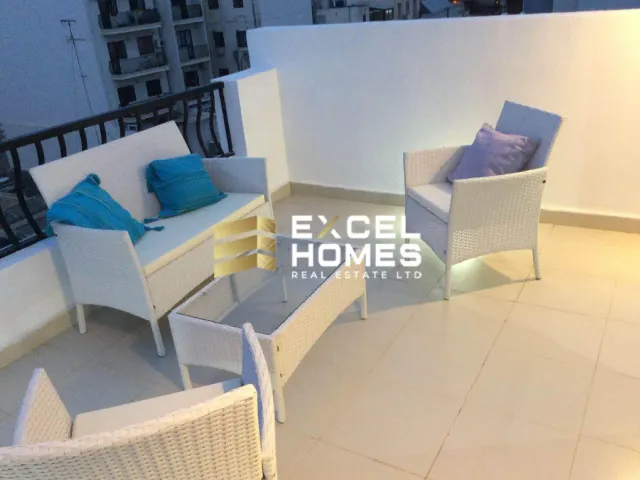a living room with a couch, chair, and a table