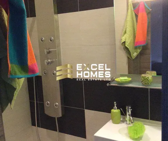 a bathroom with a shower curtain and a towel dispenser