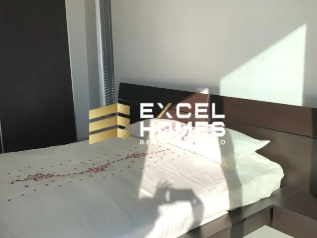 a bed with a white bedspread and a black and white bedspread