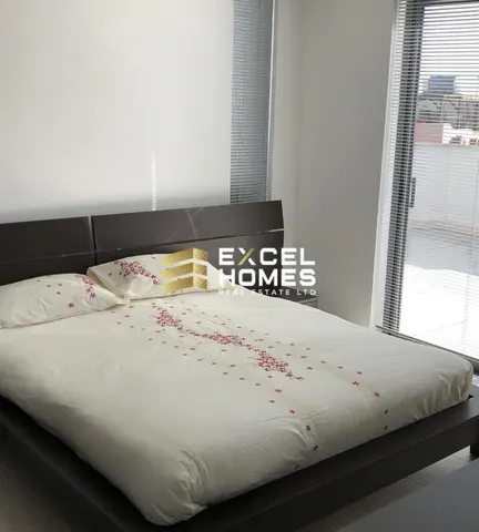 a bed with a white bedspread and a white pillow