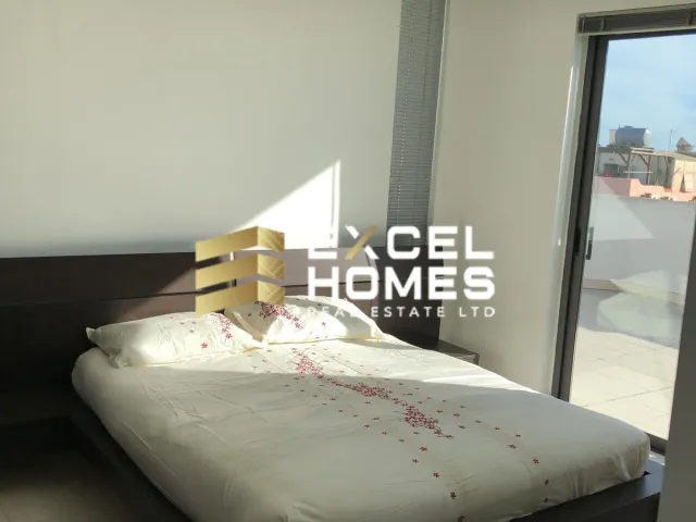 a bed with a white bedspread and a black and white bedspread