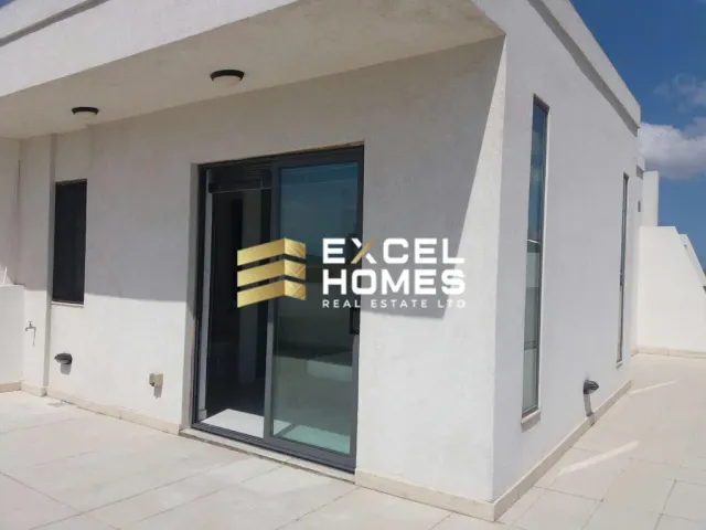 a white building with a window and a blue wall