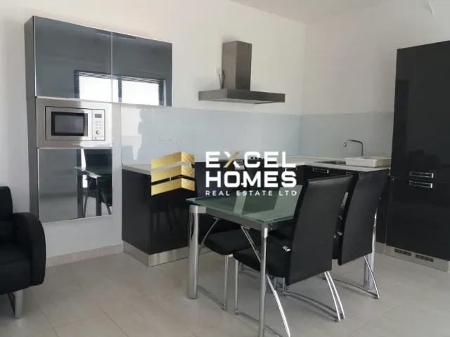 a kitchen with a table and chairs and a television